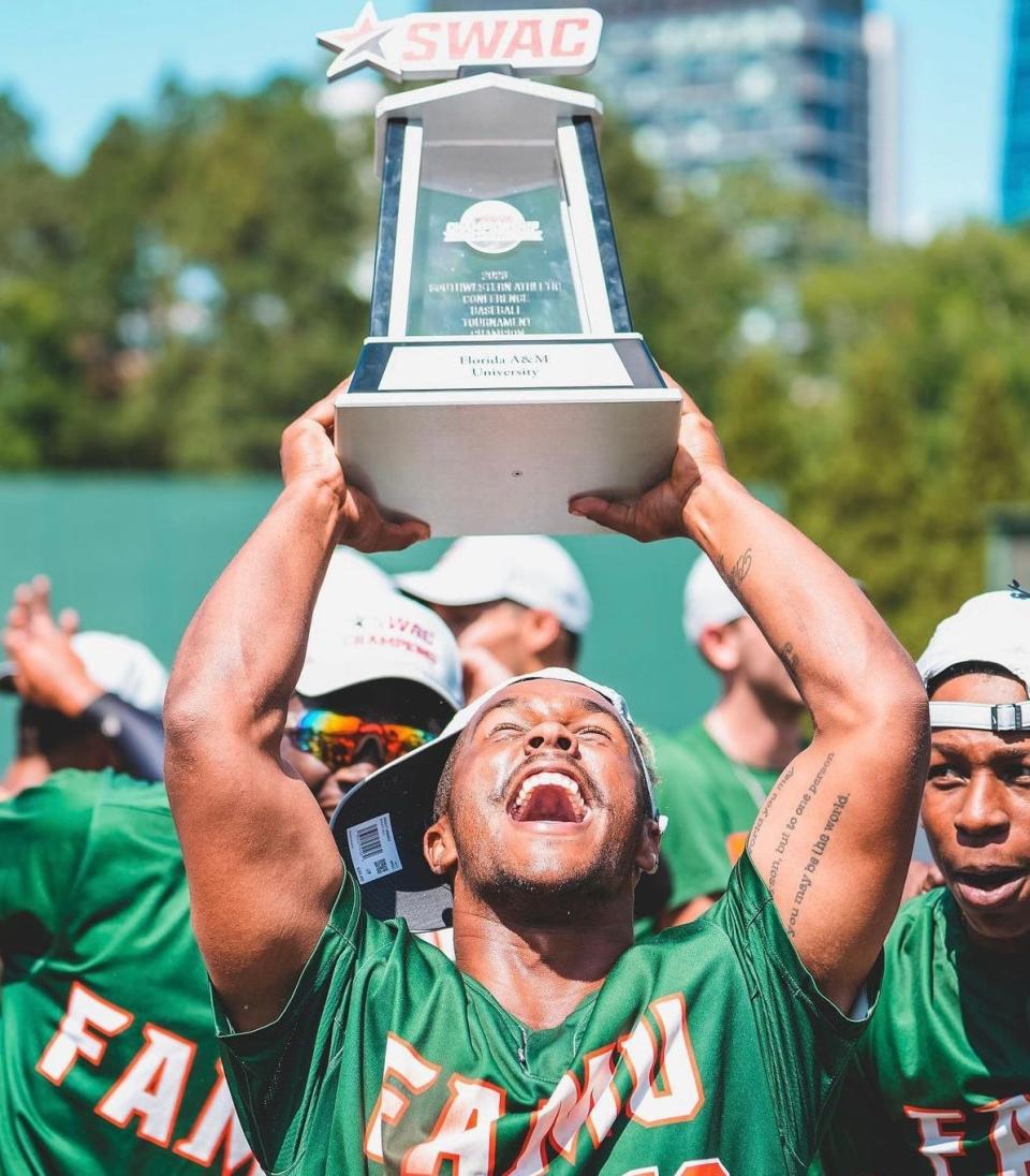 Florida A&M baseball outfielder Ty Jackson hoists the SWAC Championship trophy after defeating Bethune-Cookman at Georgia Tech's Russ Chandler Stadium in Atlanta, Georgia, Sunday, May 28, 2023