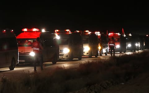 Buses carrying members of the Islamic State (IS) group and their families drive in the Qara area in Syria's Qalamoun region on August 28, 2017 - Credit:  LOUAI BESHARA/AFP