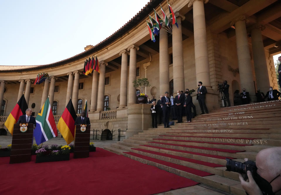 German Chancellor Olaf Scholz, left, speaks during a joint press conference with South Africa President Cyril Ramaphosa at the Union Building in Pretoria, South Africa, Tuesday, May 24, 2022. (AP Photo/Themba Hadebe)