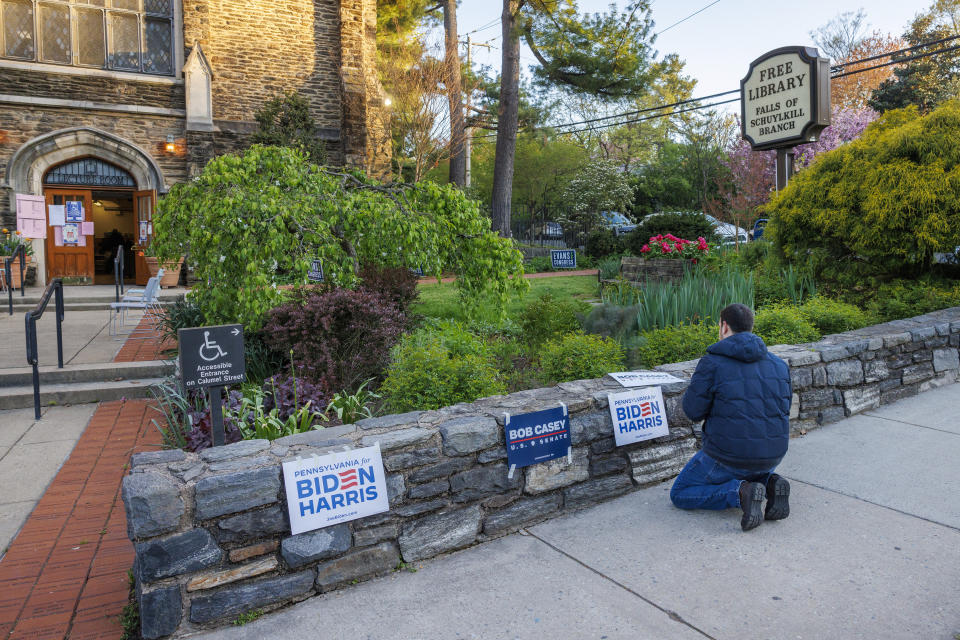 Max Weisman, Communications Director with City Councilman Isaiah Thomas volunteers at a polling place inside the Free Library Falls of Schuylkill Branch in East Falls section of Philadelphia, as it prepares to open on election day, Tuesday, April 23, 2024. (Alejandro A. Alvarez/The Philadelphia Inquirer via AP)