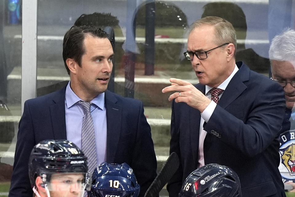Florida Panthers head coach Paul Maurice, right, talks with assistant coach Tuomo Ruutu, left, during the third period of an NHL hockey game against the Buffalo Sabres, Saturday, April 13, 2024, in Sunrise, Fla. (AP Photo/Lynne Sladky)