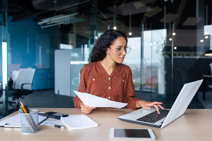 A woman looking up different tax filing deadlines and late payment consequences.