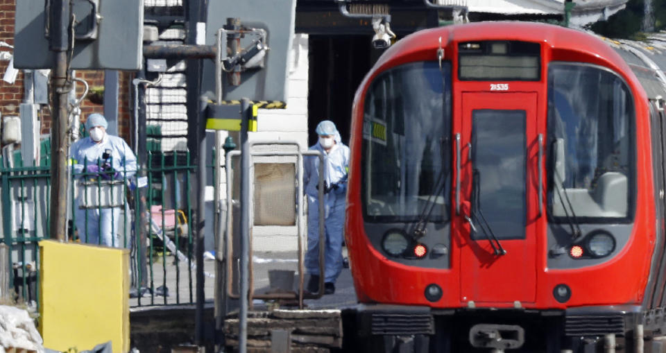 Police forensics officers work alongside a London Tube train at Parsons Green station in West London on Sept. 15, 2017, after an apparent terrorist incident.