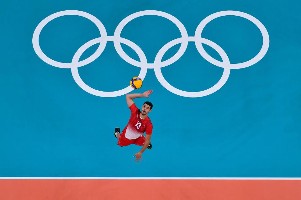 <p>Tunisia's Selim Mbareki serves in the men's preliminary round pool B volleyball match between Argentina and Tunisia during the Tokyo 2020 Olympic Games at Ariake Arena in Tokyo on July 30, 2021. (Photo by Antonin THUILLIER / AFP) (Photo by ANTONIN THUILLIER/AFP via Getty Images)</p> 