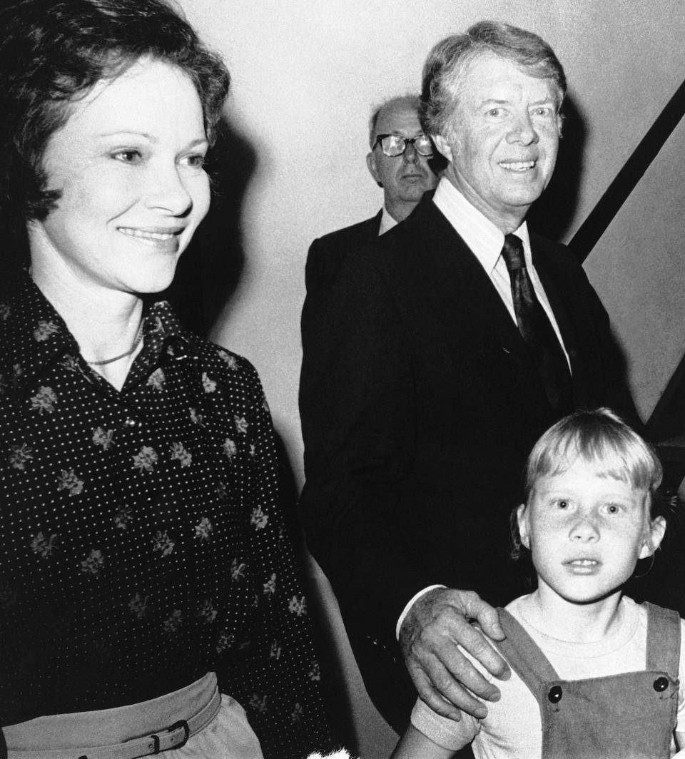 FILE - Democratic presidential candidate Jimmy Carter with his wife Rosalynn and daughter Amy head to a motel room in Orlando, Fla., March 9, 1976, to watch Florida Primary returns on television. Rosalynn Carter, the closest adviser to Jimmy Carter during his one term as U.S. president and their four decades thereafter as global humanitarians, died Sunday, Nov. 19, 2023. She was 96. (AP Photo, File)