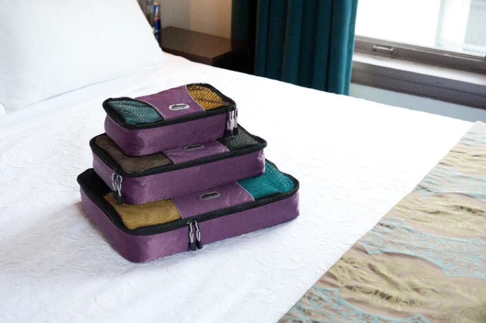 This undated image provided by eBags.com shows a set of the company’s packing cubes on a bed in a hotel room. Peter Cobb, the company’s co-founder, says the packing cubes _ which help travelers organize their belongings and save space when packing for trips _ are the website’s #1 bestselling product out of 50,000. (AP Photo/eBags.com)