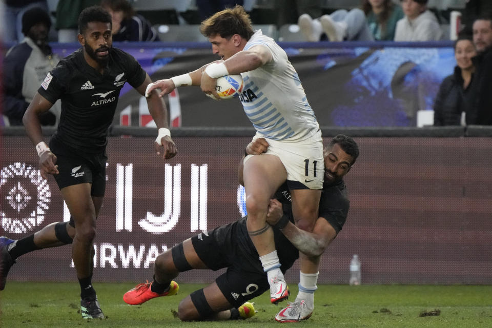 Argentina's Luciano Gonzalez is tackled by New Zealand's Amanaki Nicole during the World Rugby Sevens Series final match Sunday, Feb. 26, 2023, in Carson, Calif. (AP Photo/Marcio Jose Sanchez)