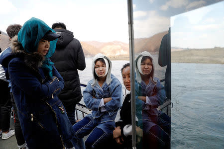 Tourists travel on a boat taking them from the Chinese side of the Yalu River for sightseeing close to the shores of North Korea, near Dandong, China's Liaoning province, April 1, 2017. REUTERS/Damir Sagolj