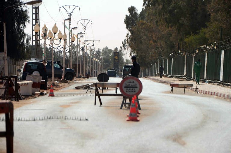 Algerian police stop cars at a checkpoint in In Amenas, deep in the Sahara near the Libyan border, on January 18, 2013 as Islamist hostage-takers at a nearby gas field in the area, more than 1,300 kms southeast of the capital Algiers, demanded a prisoner swap and an end to the French military campaign in Mali