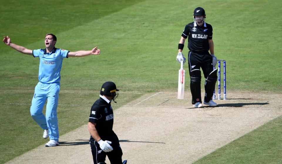 England's Chris Woakes (L) celebrates after the dismissal of New Zealand's Henry Nicholls (R) as New Zealand's Martin Guptill (C) looks on during the 2019 Cricket World Cup group stage match between England and New Zealand at the Riverside Ground, in Chester-le-Street, northeast England, on July 3, 2019. (Photo by Paul ELLIS / AFP) / RESTRICTED TO EDITORIAL USE        (Photo credit should read PAUL ELLIS/AFP/Getty Images)