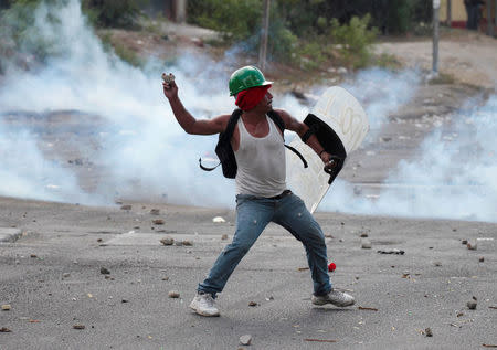 A demonstrator throws stones towards riot police during a protest over a controversial reform to the pension plans of the Nicaraguan Social Security Institute (INSS) in Managua, Nicaragua April 21, 2018. REUTERS/Oswaldo Rivas