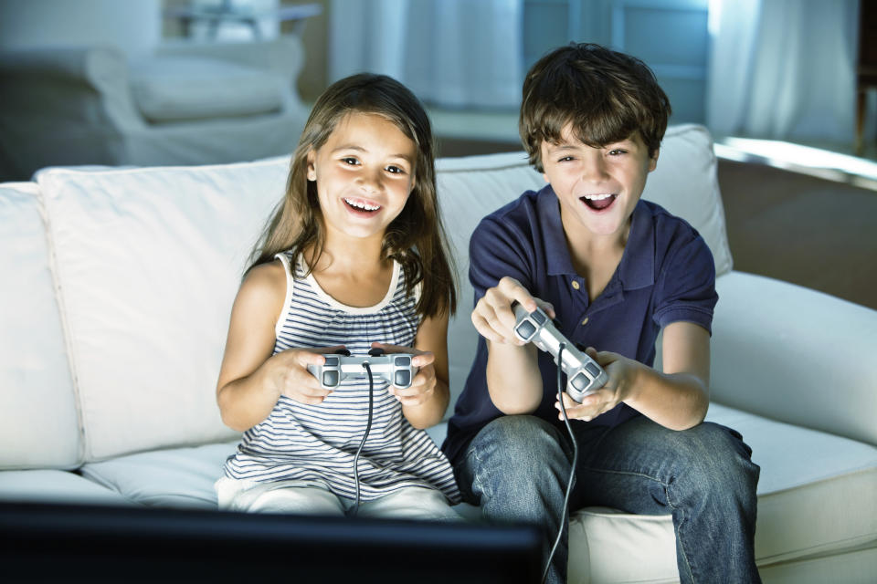 Children playing video game at home