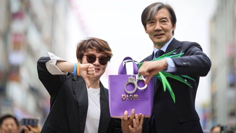 An opposition leader, Cho Kuk, campaigning with a Dior handbag and spring onions