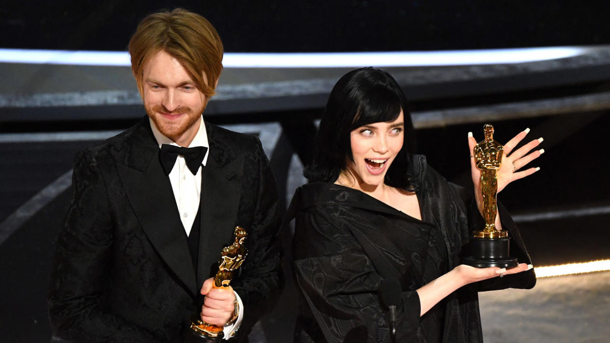  US singer-songwriter Finneas O'Connell (L) and US singer-songwriter Billie Eilish accept the award for Best Music (Original Song) for "No Time to Die" onstage during the 94th Oscars at the Dolby Theatre in Hollywood, California on March 27, 2022 