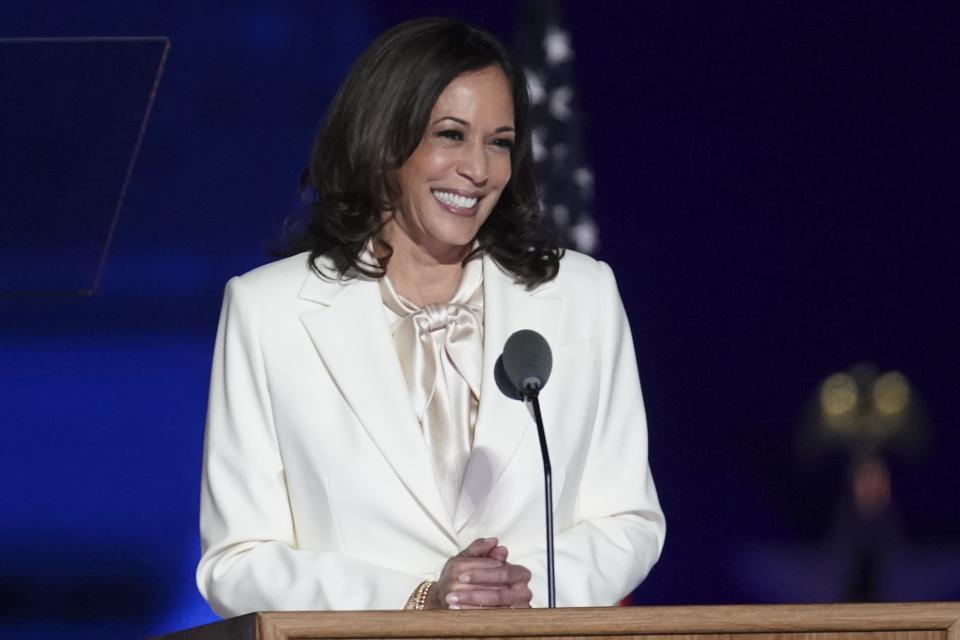 Harris nods to suffragettes in white Carolina Herrera during a November speech.