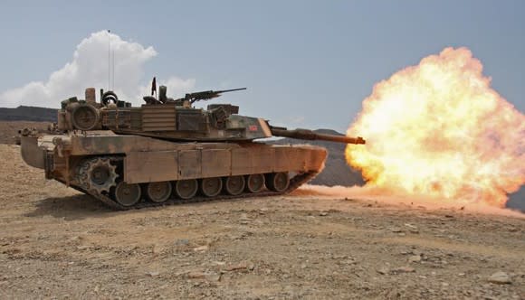 M1 Abrams tank shooting a fireball.