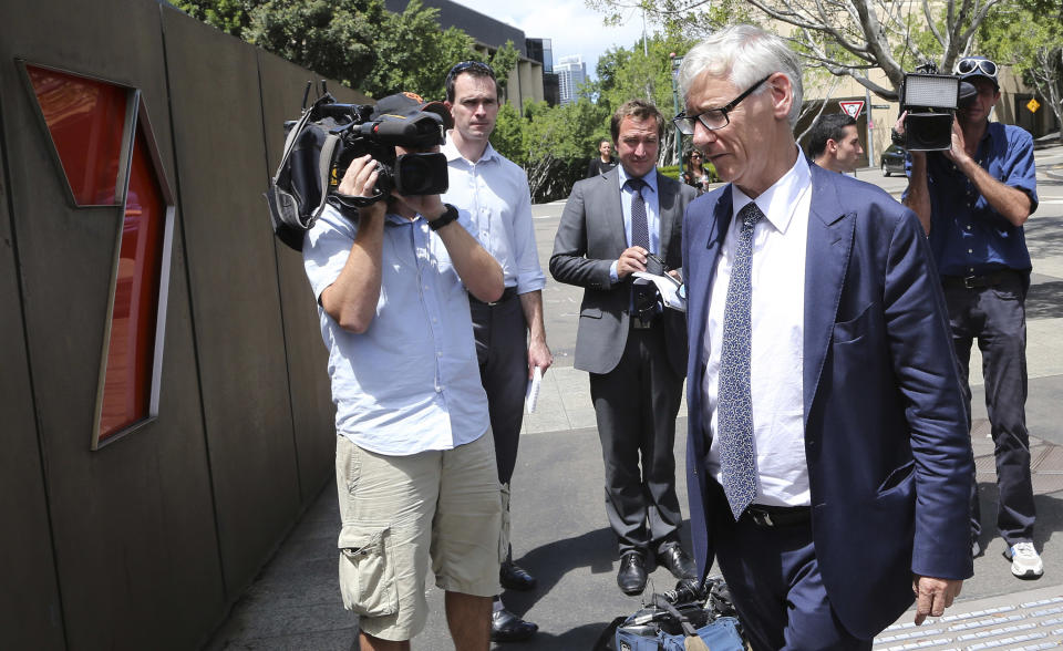 Chief Legal and Commercial Director of Seven Network Bruce Ian McWilliam , front right, arrives to speak to the media after Australian Federal Police raided their headquarters in Sydney, Australia, Tuesday, Feb. 18, 2014. Police seeking to prevent a convicted drug trafficker from profiting from her life story have raided the Sydney headquarters of the television network that is negotiating an exclusive interview deal. (AP Photo/Rob Griffith)