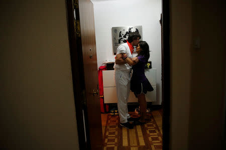 Sergio Colas bids farewell to his wife Alma as he leaves to take part in the first bull run of the San Fermin festival in Pamplona, northern Spain, July 7, 2016. REUTERS/Susana Vera