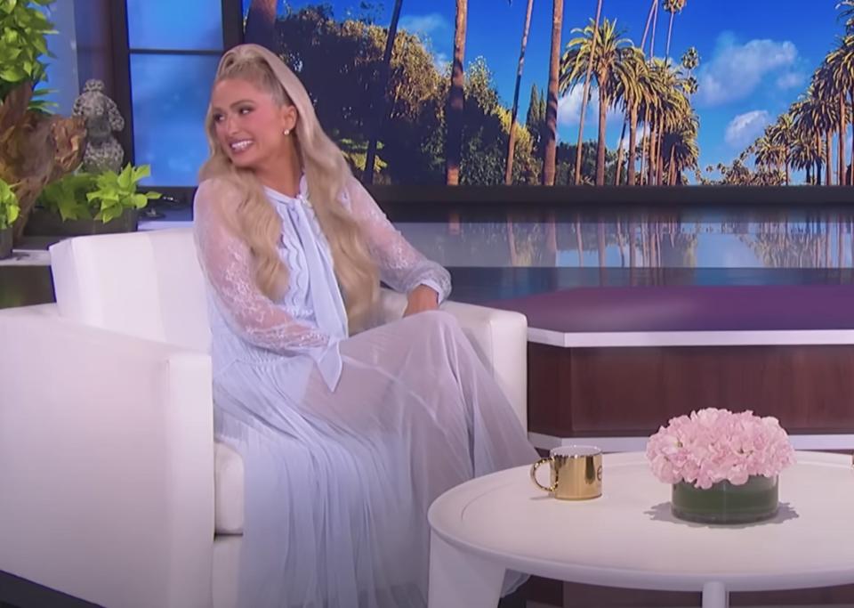 Paris looks to the left at someone off camera on Ellen's show