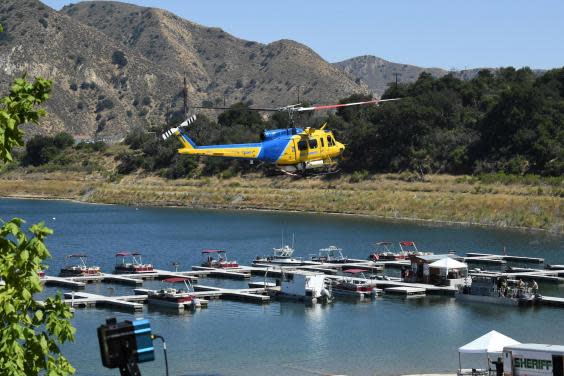 A Ventura County Sheriff’s helicopter returns to base during the search to find Naya Rivera on 10 July 2020 at Lake Piru, California. (ROBYN BECK/AFP via Getty Images)