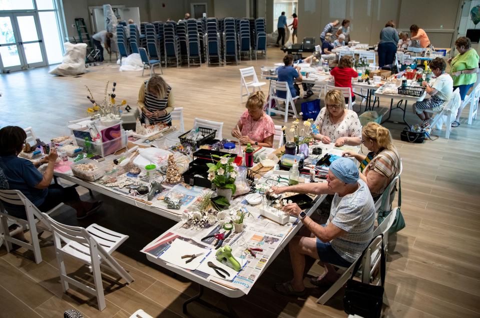 A group of shell artists work on pieces made from sea shells at the Sanibel Community House on Monday, Feb. 12, 2024, on Sanibel Island. The group is making items for the 87th Annual Sanibel Shell Festival, which is being held March 7-9, 2024 at the Community House.