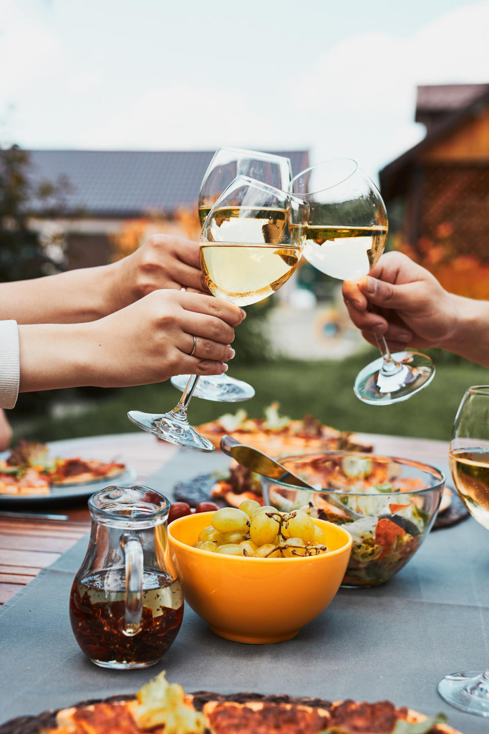 Friends toasting at an outdoor dinner party.