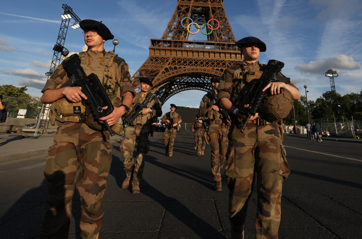 French soldiers patrol near to Eiffel Tower in Paris on July 21, 2024, ahead of the Paris 2024 Olympic and Paralympic Games. (Photo by AHMAD GHARABLI / AFP) (Photo by AHMAD GHARABLI/AFP via Getty Images)