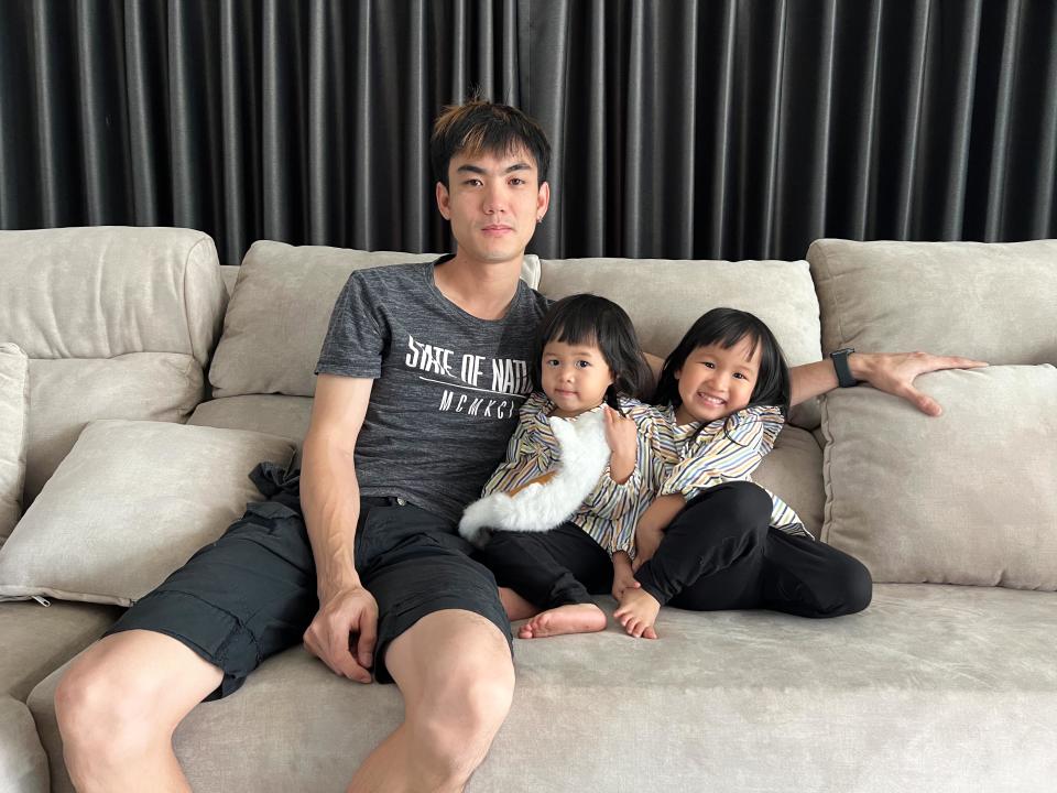 Kana Kanuengnit, 3, and two-year-old Kaning pictured with their dad, Apisit.