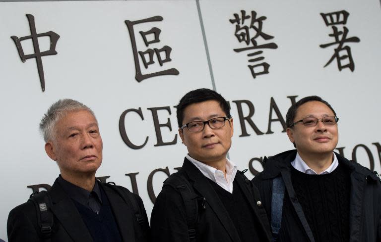 The three original founders of the 'Occupy' pro-democracy movement -- Chu Yiu-ming, Chan Kin-man and Benny Tai -- surrender to police in Hong Kong, on December 3, 2014