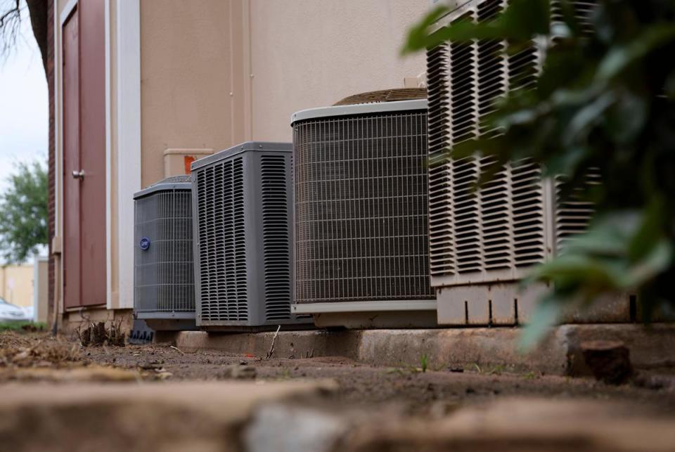 A group of air conditioning units are pictured outside the Wildflower Apartments in Midland, Texas, on April 21, 2024.