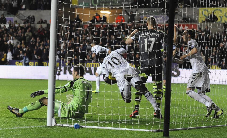 Swansea City's Wilfried Bony (C) retrieves the ball after scoring a goal against Stoke City during their English Premier League soccer match at the Liberty Stadium in Swansea, Wales, November 10, 2013.