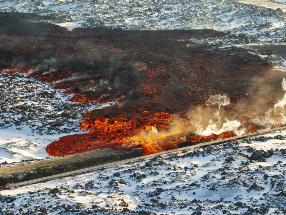 A view of lava hitting the hot water pipeline flowing on the road leading to the Blue Lagoon, in Grindavík, Iceland, Thursday, Feb. 8, 2024. A volcano in southwestern Iceland has erupted for the third time since December and sent jets of lava into the sky. The eruption on Thursday morning triggered the evacuation the Blue Lagoon spa which is one of the island nation’s biggest tourist attractions. (AP Photo /Marco Di Marco). (AP Photo /Marco Di Marco)