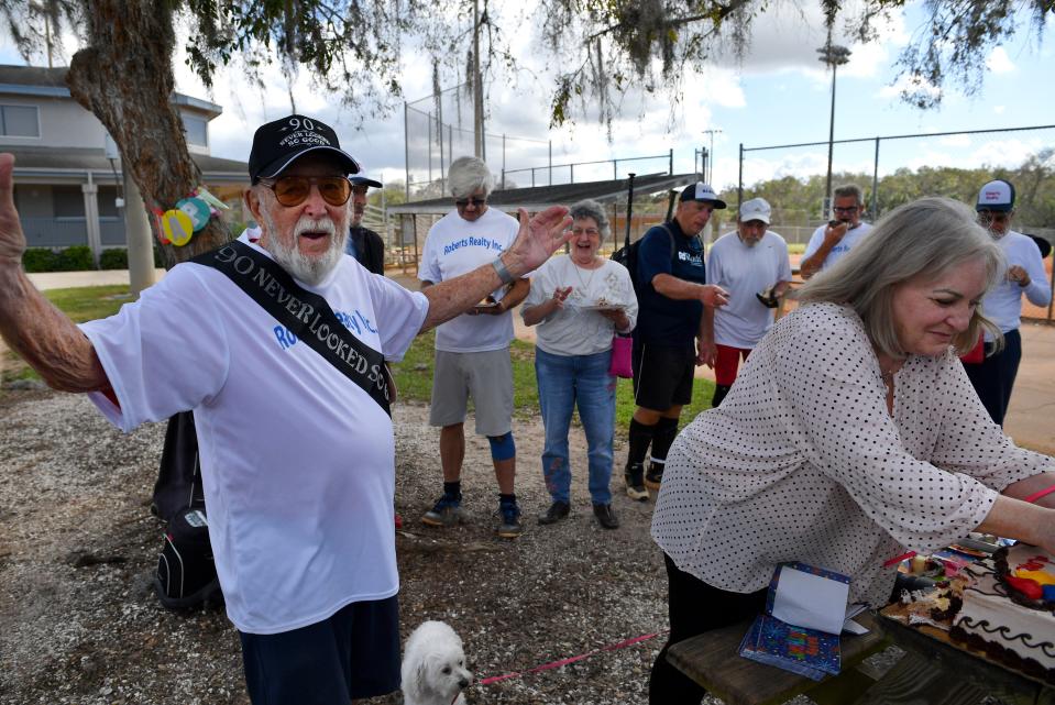 Dave Wulfsohn, 90, reacts after friends sang "Happy Birthday" following a game at Sarasota Senior Softball Thursday at 17th Street Park. Wulfson's daughter Leslie Loftus Wulfsohn, right, cuts the birthday cake. 