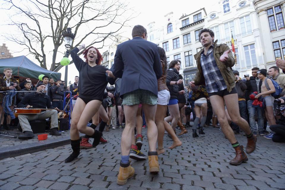 People take part in the annual "No Pants Subway Ride" celebrations on the streets of Brussels January 12, 2014. The event involves participants who strip down to their underwear as they go about their normal routine, and occurs in different cities around the world in January, according to its organisers. REUTERS/Eric Vidal (BELGIUM - Tags: TRANSPORT SOCIETY ANNIVERSARY)