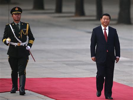 China's President Xi Jinping walks next to a honour guard during the welcoming ceremony for Serbian President Tomislav Nikolic outside the Great Hall of the People in Beijing August 26, 2013. REUTERS/Petar Kujundzic