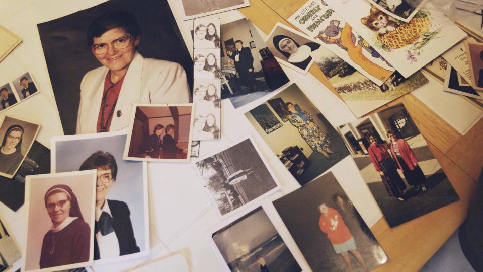 Photos of Sister Eileen Shaw are laid out on a table in Lancaster, Pennsylvania, by Trish Cahill. (Photo: HuffPost)