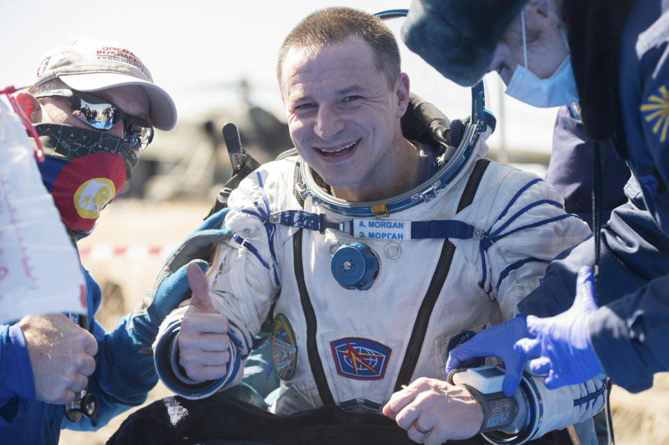 In this handout photo released by Gagarin Cosmonaut Training Centre (GCTC), Roscosmos space agency, U.S. astronaut Andrew Morgan gestures shortly after the landing of the Russian Soyuz MS-15 space capsule near Kazakh town of Dzhezkazgan, Kazakhstan, Friday, April 17, 2020. An International Space Station crew has landed safely after more than 200 days in space. The Soyuz capsule carrying NASA astronauts Andrew Morgan, Jessica Meir and Russian space agency Roscosmos' Oleg Skripochka touched down on Friday on the steppes of Kazakhstan. (Andrey Shelepin, Gagarin Cosmonaut Training Centre (GCTC), Roscosmos space agency, via AP)