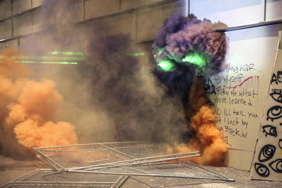 Smoke fills the street as police respond to protesters during a demonstration, Friday, July 17, 2020 in Portland, Ore. Militarized federal agents deployed by the president to Portland, fired tear gas against protesters again overnight as the city’s mayor demanded that the agents be removed and as the state’s attorney general vowed to seek a restraining order against them. (Dave Killen/The Oregonian via AP)