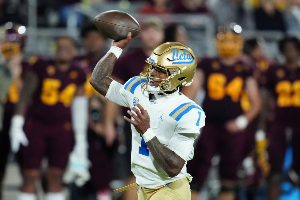 UCLA quarterback Dorian Thompson-Robinson (1) throws a touchdown pass against Arizona State during the first half of an NCAA college football game in Tempe, Ariz., Saturday, Nov. 5, 2022. (AP Photo/Ross D. Franklin)