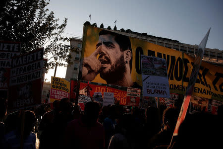 Protesters hold a banner depicting Greek late anti-fascist rapper Pavlos Fyssas during a rally marking four years since the fatal stabbing of Fyssas by a supporter of the ultranationalist Golden Dawn party in Athens, Greece, September 16, 2017. REUTERS/Alkis Konstantinidis