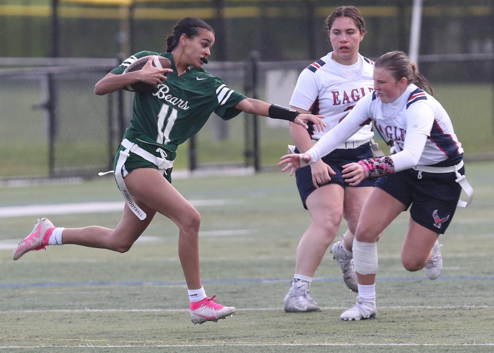 Brewster's Sienna Santiago (11) looks for some running room in the Eastchester defense during flag football playoff action at Brewster High School May 15, 2024. Brewster won the game 27-21.