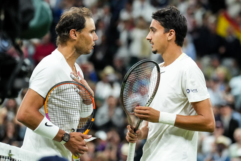 Rafa Nadal, pictured here speaking with Lorenzo Sonego during their match at Wimbledon.