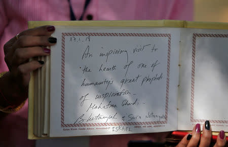 A woman shows the message written by Israeli Prime Minister Benjamin Netanyahu in the visitor's book during his visit to Gandhi Ashram in Ahmedabad, India, January 17, 2018. REUTERS/Amit Dave