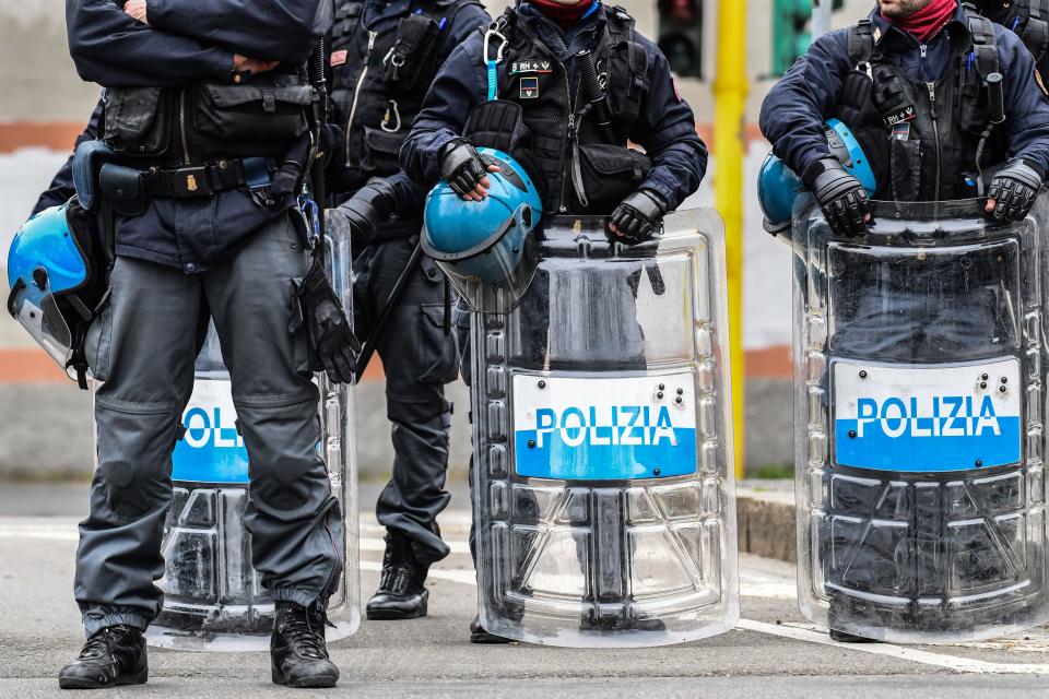 Anti-riot police officers stand guard outside the San Vittore prison in Milan as inmates (not in picture) stage a protest on a rooftop of a wing at the prison on March 9, 2020, in one of Italy's quarantine red zones. - Inmates in four Italian prisons have revolted over new rules introduced to contain the coronavirus outbreak, leaving one prisoner dead and others injured, a prison rights group said on March 8. Prisoners at jails in Naples Poggioreale in the south, Modena in the north, Frosinone in central Italy and at Alexandria in the northwest had all revolted over measures including a ban on family visits, unions said. (Photo by Miguel MEDINA / AFP) (Photo by MIGUEL MEDINA/AFP via Getty Images)