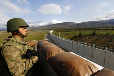 A Turkish soldier surveys the border between Turkey and Syria from a watch-tower near the southeastern city of Kilis, Turkey, March 2, 2017. REUTERS/Murad Sezer