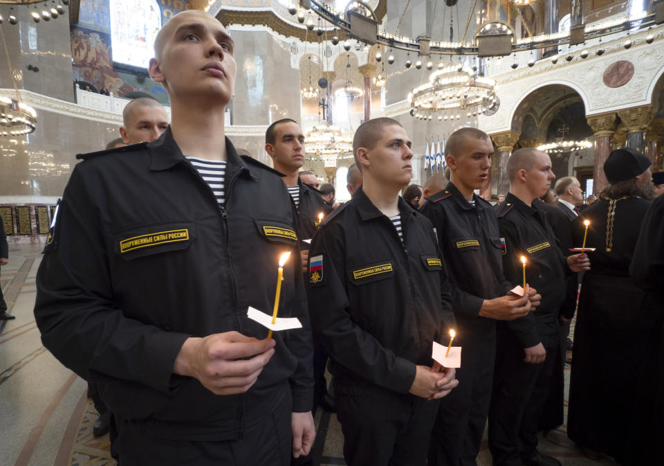 Navy sailors attend a religion service to commemorate the crew members that were killed on one of the Russian navy's deep-sea research submersibles at Kronshtadt Navy Cathedral outside St.Petersburg, Russia, Thursday, July 4, 2019. Some crew members survived a fire that killed 14 sailors on one of the Russian navy's deep-sea submersibles, Russia's defense minister said Wednesday without specifying the number of survivors from the blaze. (AP Photo/Dmitri Lovetsky)