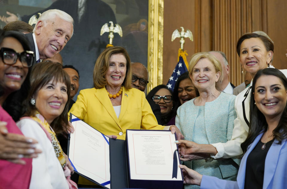 Nancy Pelosi, surrounded by House Democrats.