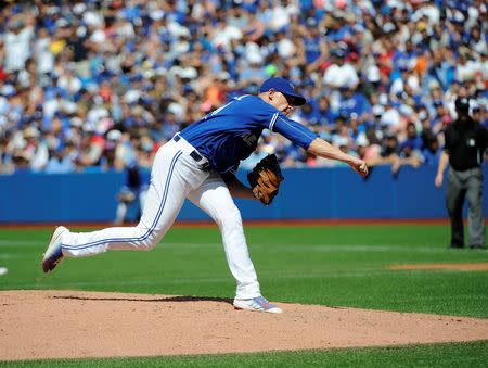 Aug 2, 2015; Toronto, Ontario, CAN; Toronto Blue Jays relief pitcher Aaron Sanchez (41) pitches and hits Kansas City Royals short stop Alcides Escobar (2) (not in picture) and gets ejected by home plate umpire Jim Wolf in the eighth inning against Kansas City Royals at Rogers Centre. Peter Llewellyn-USA TODAY Sports