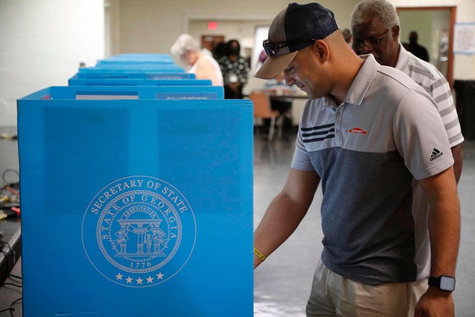 A voter prepares to cast his ballot during the primary on Tuesday at the Progressive Recreation Center in Garden City.