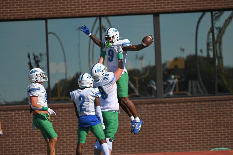 University of West Florida running back Jamontez Woods (9) is lifted up in the air in celebration after his touchdown run during the Argos' 42-14 win at Mississippi College on Saturday, Nov. 4, 2023.
